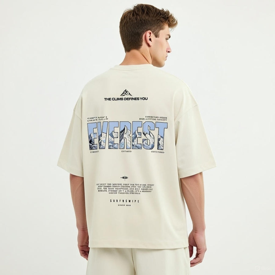 Person wearing a beige t-shirt with 'Everest' graphic and text on the back