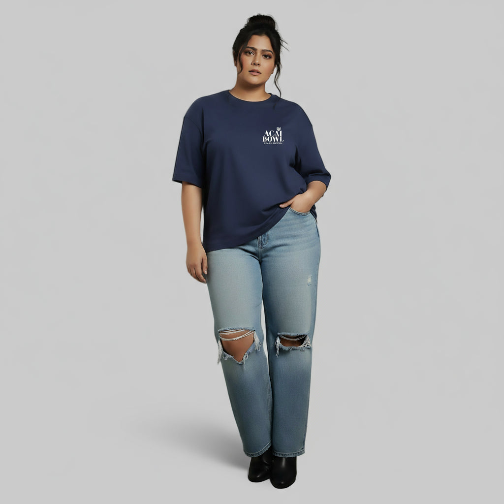 Person wearing a navy blue oversized t-shirt and light blue jeans against a plain background