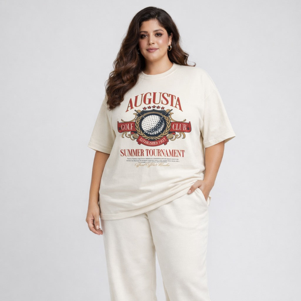 Woman wearing a white t-shirt with 'Augusta Golf Club' print on a plain background
