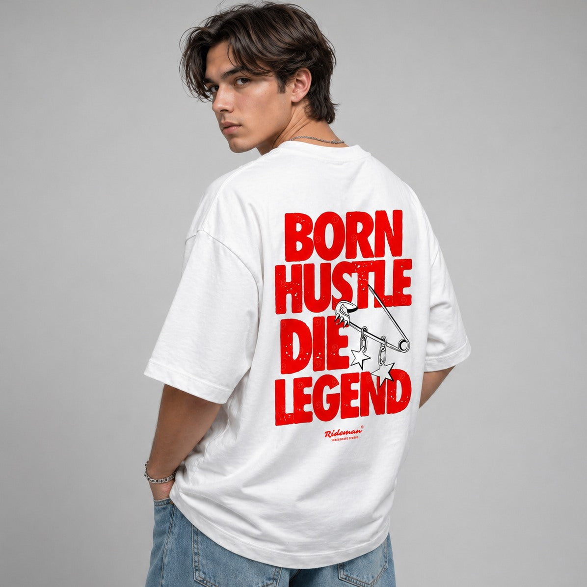 Person wearing a white t-shirt with red text on the back against a gray background