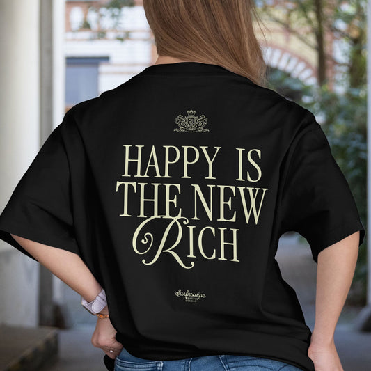 Person wearing a black t-shirt with 'Happy is the New Rich' text on the back.