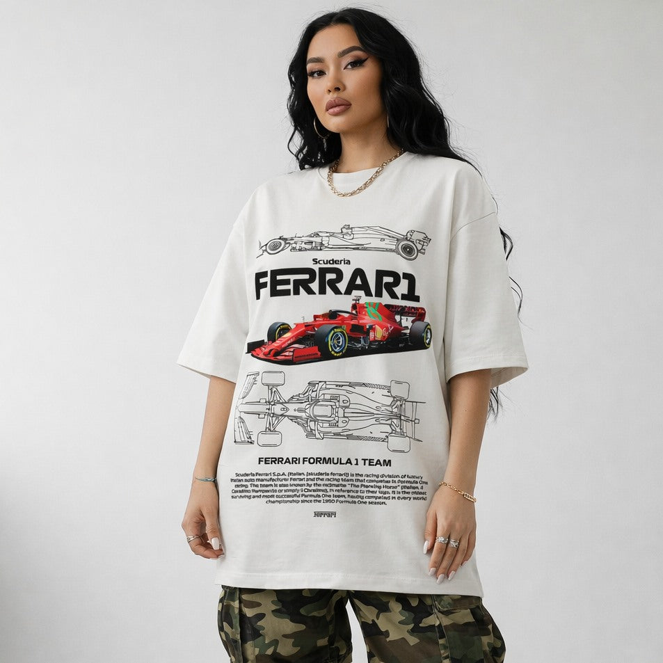 Person wearing a white Ferrari t-shirt with car graphics on a plain background