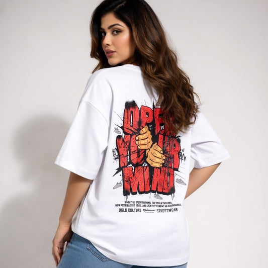 Woman wearing a white t-shirt with graphic design on the back against a plain background