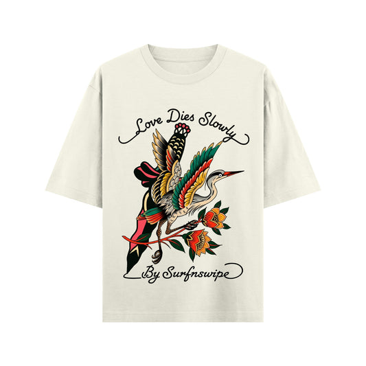 White t-shirt with colorful bird graphic and text on a white background