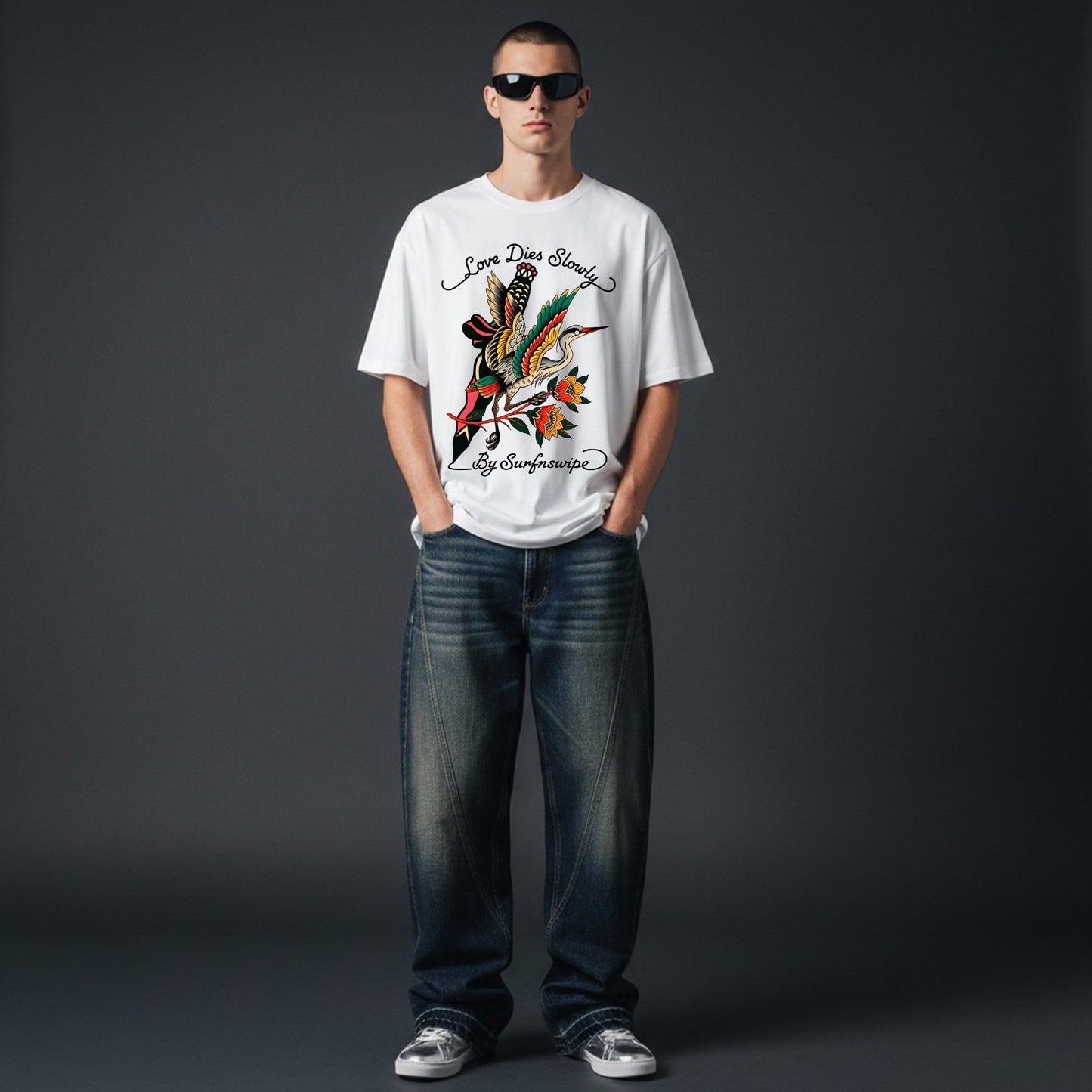 Person wearing a white t-shirt with a colorful graphic design on a dark gray background