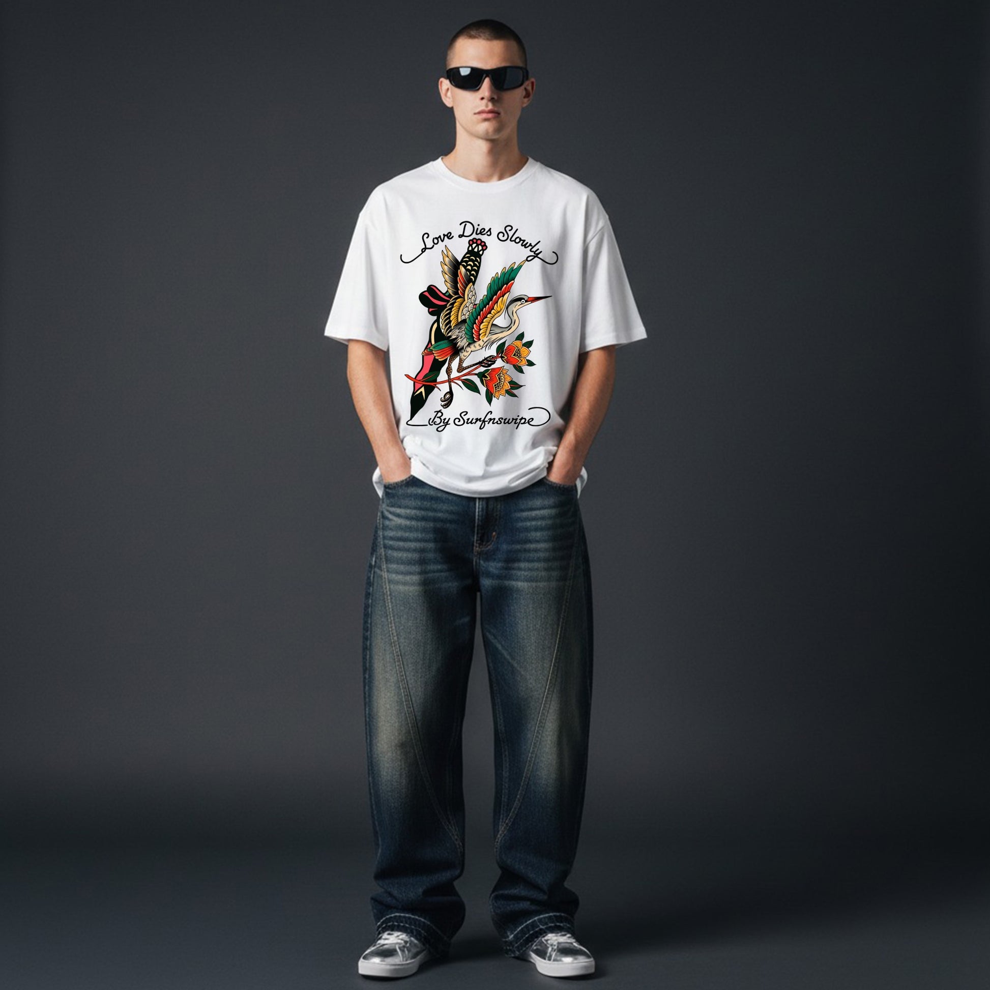 Person wearing a white t-shirt with a colorful graphic design on a dark gray background