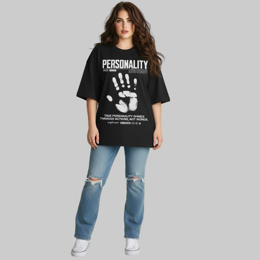 Person wearing a black t-shirt with text and graphics, standing against a plain background