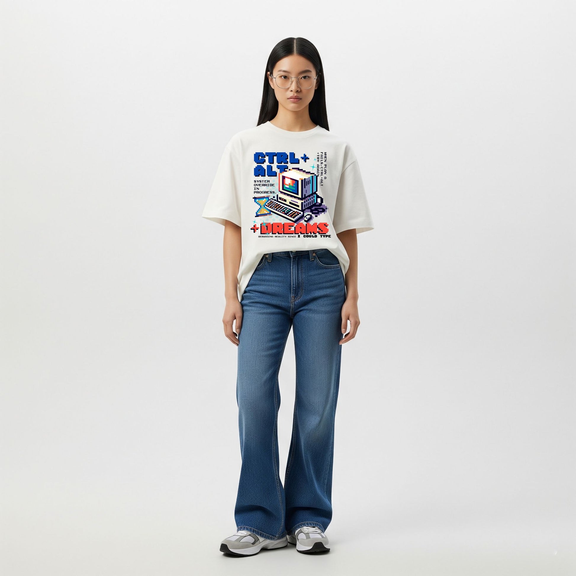 Person wearing a white t-shirt with a colorful graphic design and blue jeans on a white background