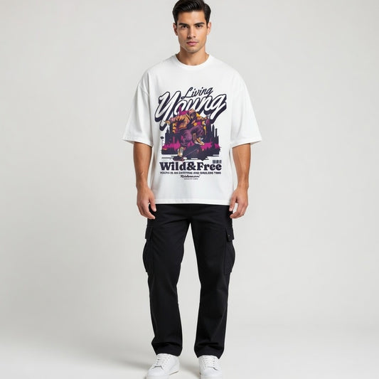 Man wearing a white t-shirt with colorful graphics and text on a plain background