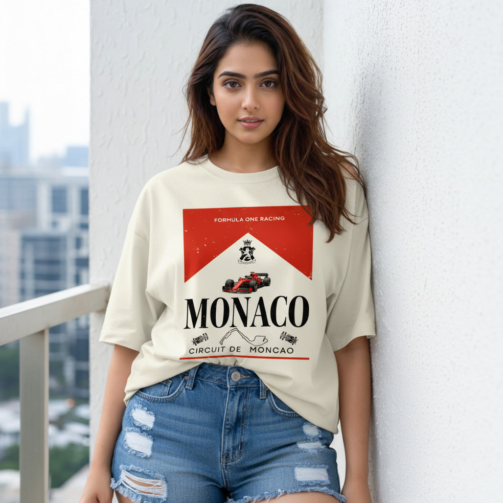 Woman wearing a t-shirt with Monaco Formula One Racing design on a balcony.