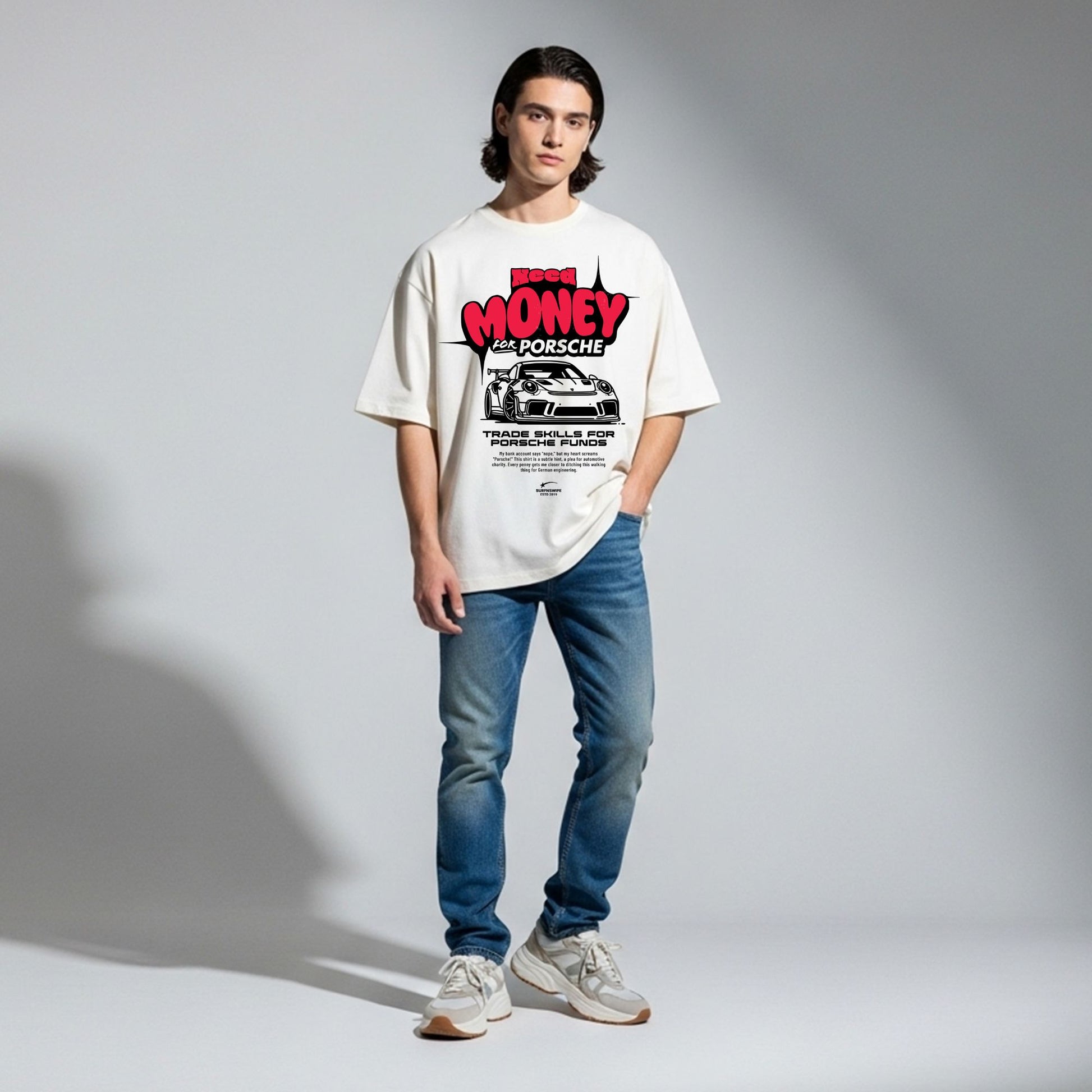 Person wearing a white t-shirt with a graphic design on a gray background
