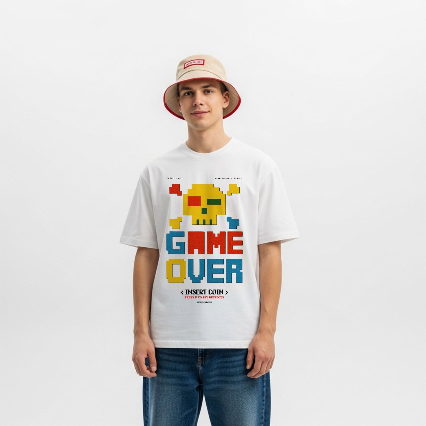 Person wearing a white t-shirt with a colorful 'GAME OVER' graphic design on a plain background