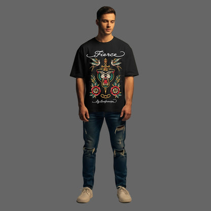 Man wearing a black t-shirt with a colorful graphic design and text, standing against a plain background.