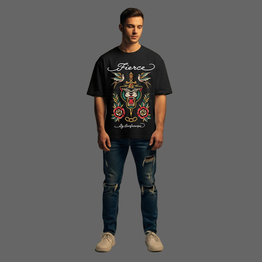 Man wearing a black t-shirt with a colorful graphic design and text, standing against a plain background.