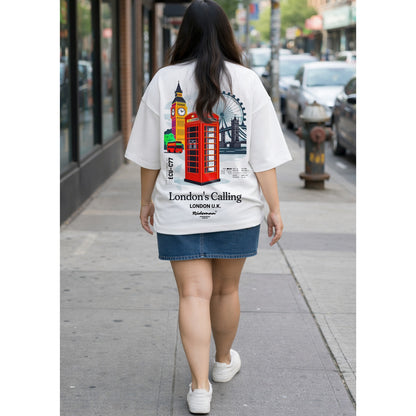 Person wearing a white t-shirt with London-themed design walking on a city street.