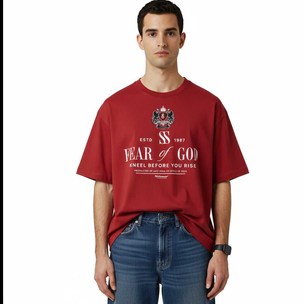 Person wearing a red 'Fear of God' t-shirt on a white background