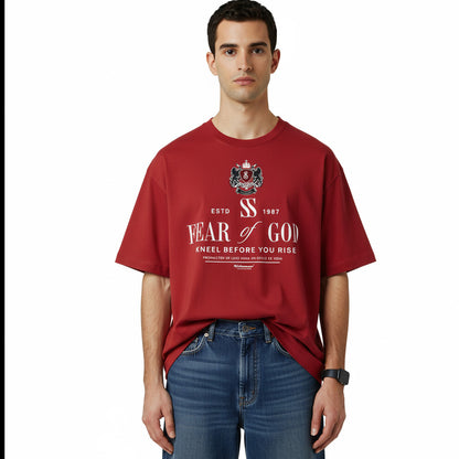 Person wearing a red 'Fear of God' t-shirt on a white background