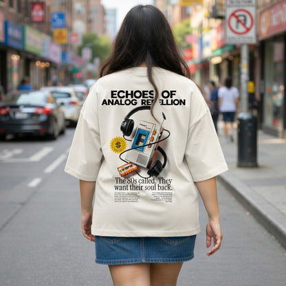 Person wearing a t-shirt with 'Echoes of Analog Rebellion' design on a city street.