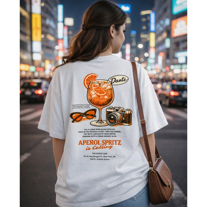 Person wearing a white t-shirt with Aperol Spritz design in an urban night setting