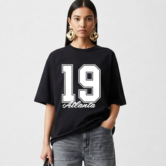 Person wearing a black t-shirt with '19 Atlanta' design on a plain background