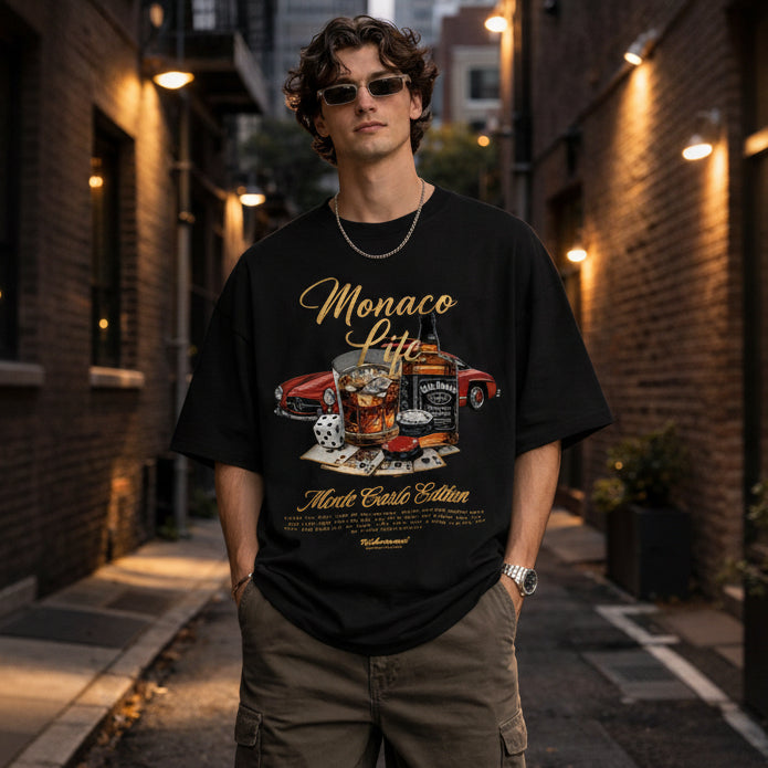 man-wearing-black-oversized-with-Monaco-print-t-shirt