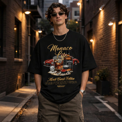 man-wearing-black-oversized-with-Monaco-print-t-shirt