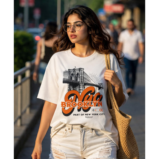 Woman wearing a 'Brooklyn' t-shirt walking outdoors.