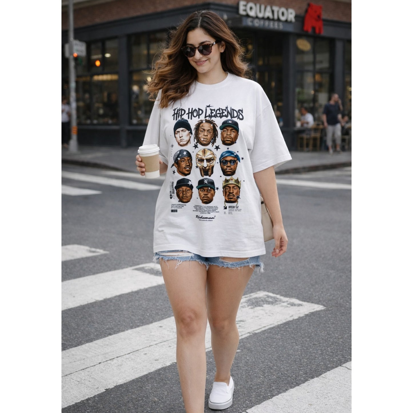 Woman wearing a white t-shirt with graphic design, standing on a city street.