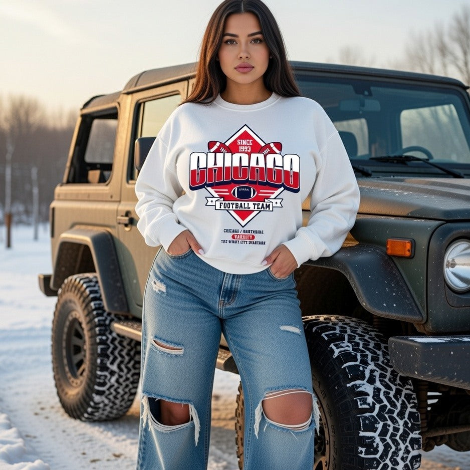 Woman wearing a sweatshirt with 'Chicago Football Team' design in front of a Jeep in a snowy setting