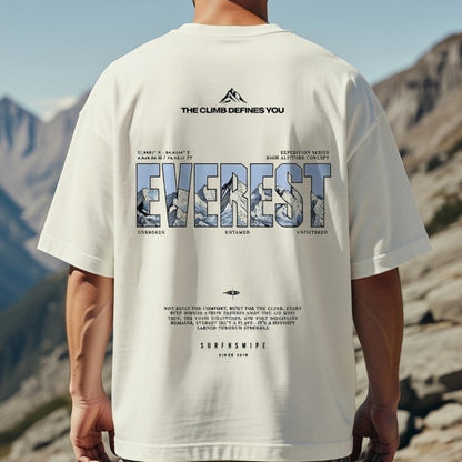 Person wearing a white t-shirt with 'Everest' and mountain-themed text against a mountainous background