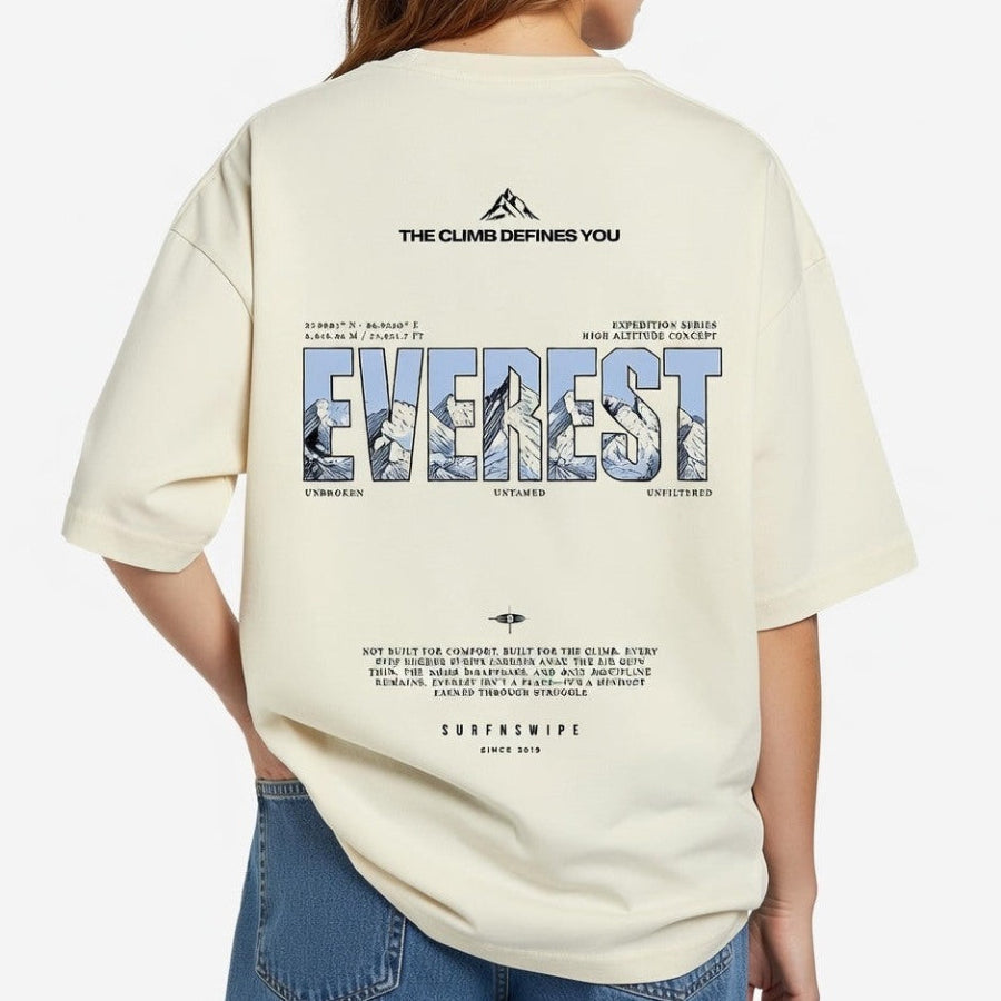 Beige t-shirt with Everest-themed design on the back, worn by a person.