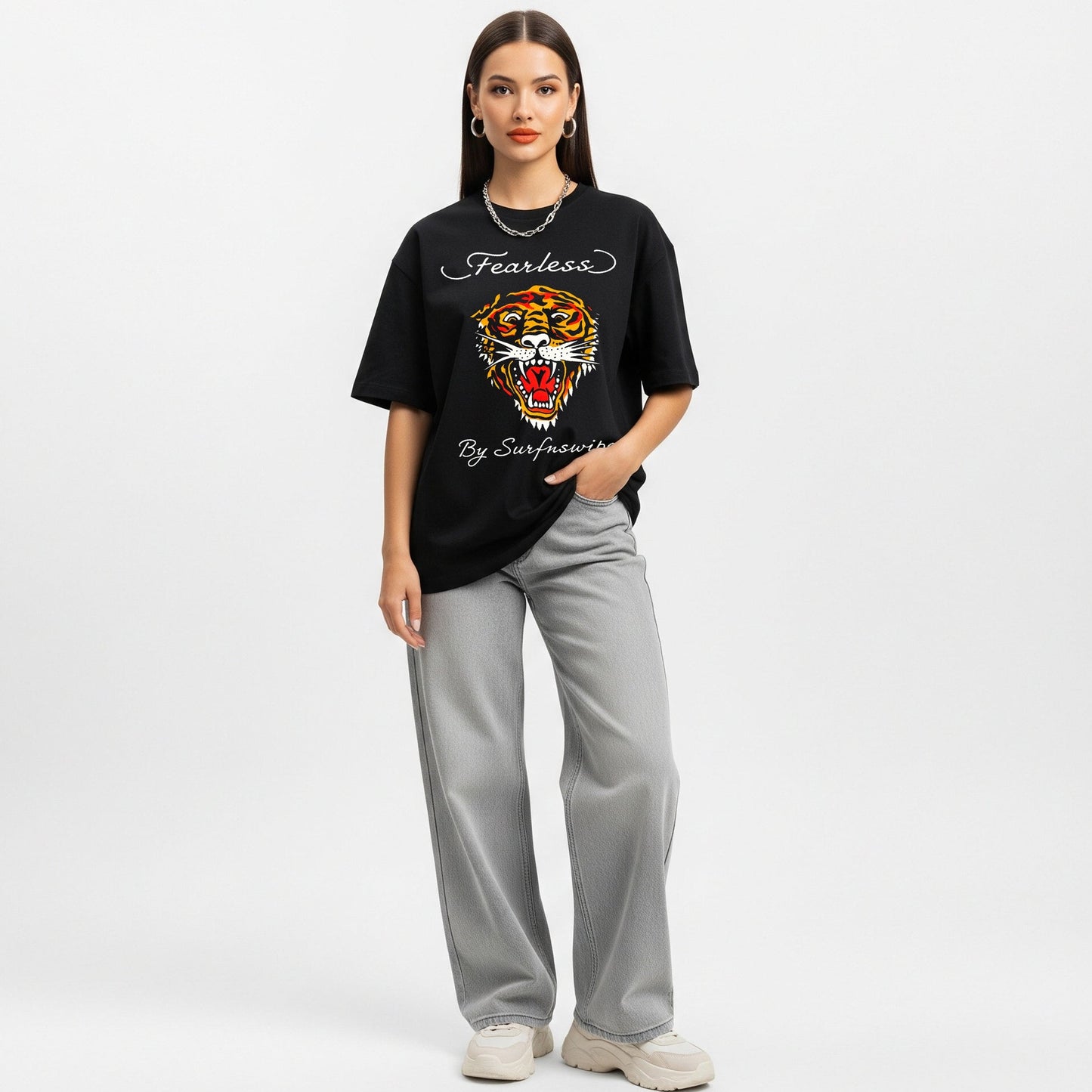 Woman wearing a black t-shirt with a tiger graphic and text on a white background