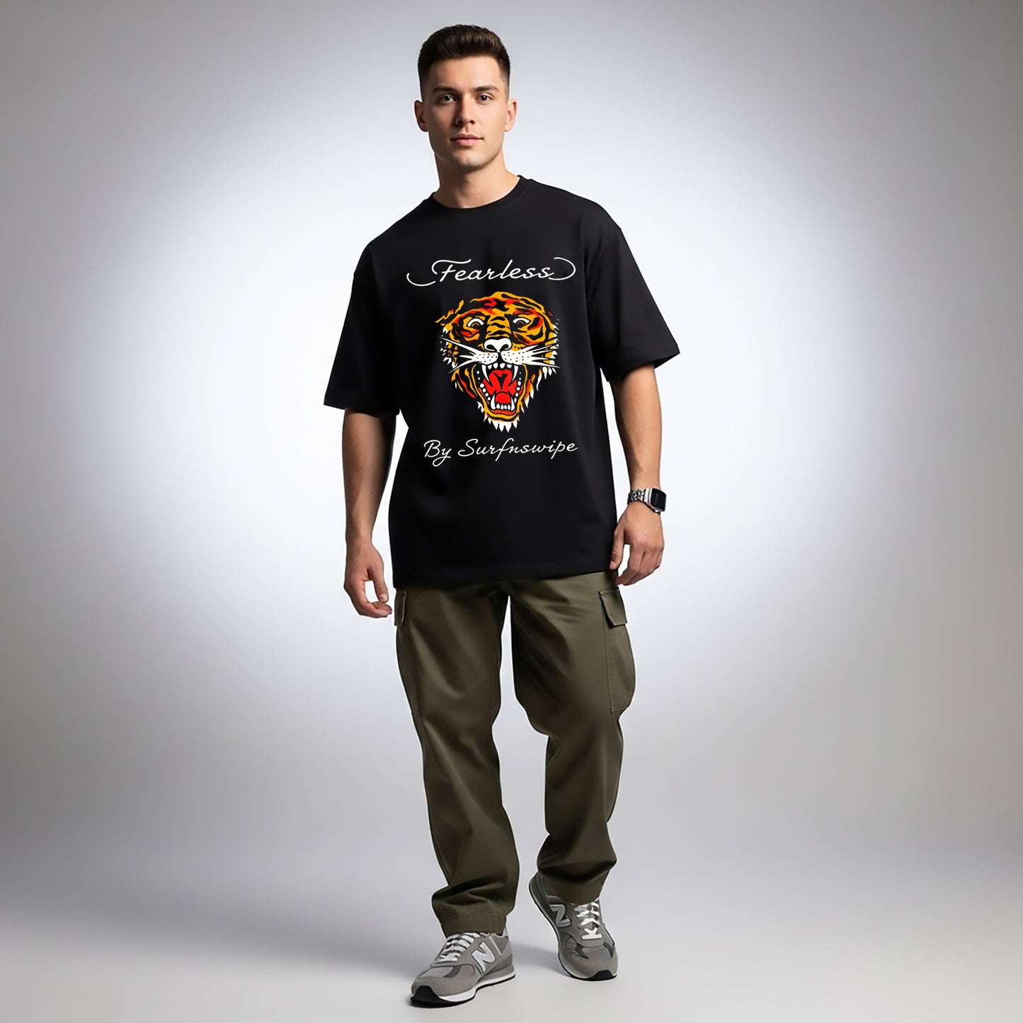 Man wearing a black t-shirt with a tiger graphic and text, standing against a plain background
