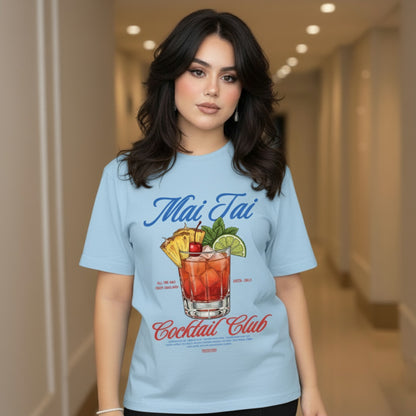 Woman wearing a light blue t-shirt with a Mai Tai Cocktail Club design.