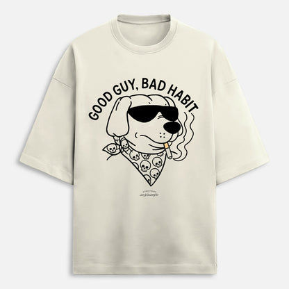 Beige t-shirt with a graphic of a dog wearing sunglasses and a bandana, with text 'Good Guy, Bad Habit'.