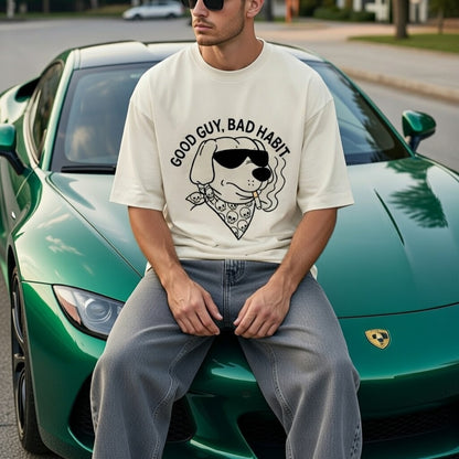 Person wearing a t-shirt with a graphic design sitting on a green sports car.