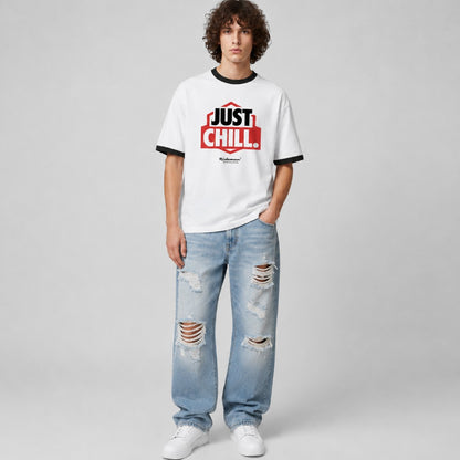 Person wearing a white t-shirt with 'Just Chill' text and ripped jeans on a gray background