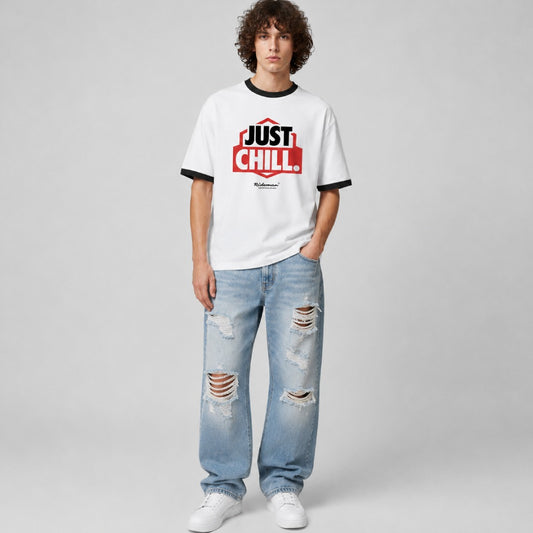 Person wearing a white t-shirt with 'Just Chill' text and ripped jeans on a gray background
