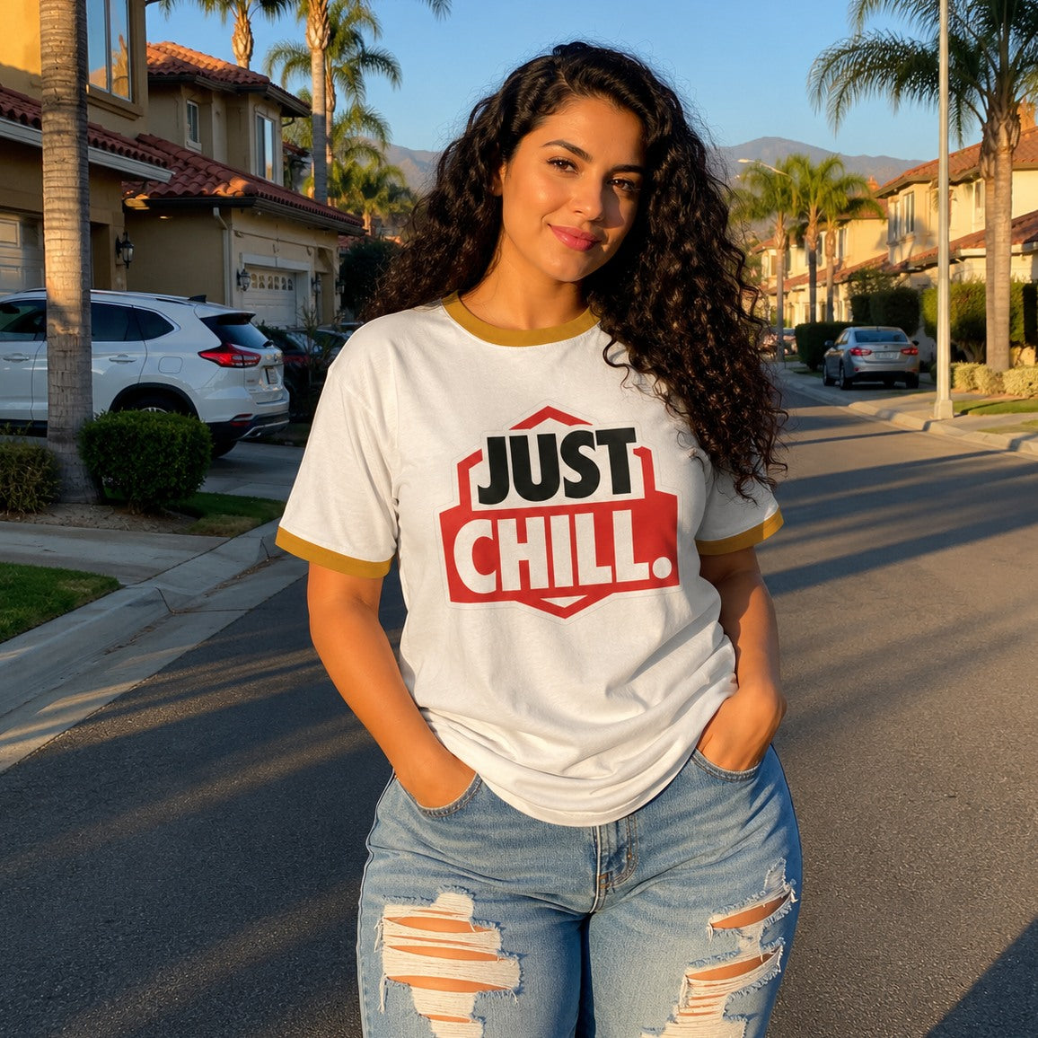 Woman wearing a 'Just Chill' t-shirt standing on a residential street.