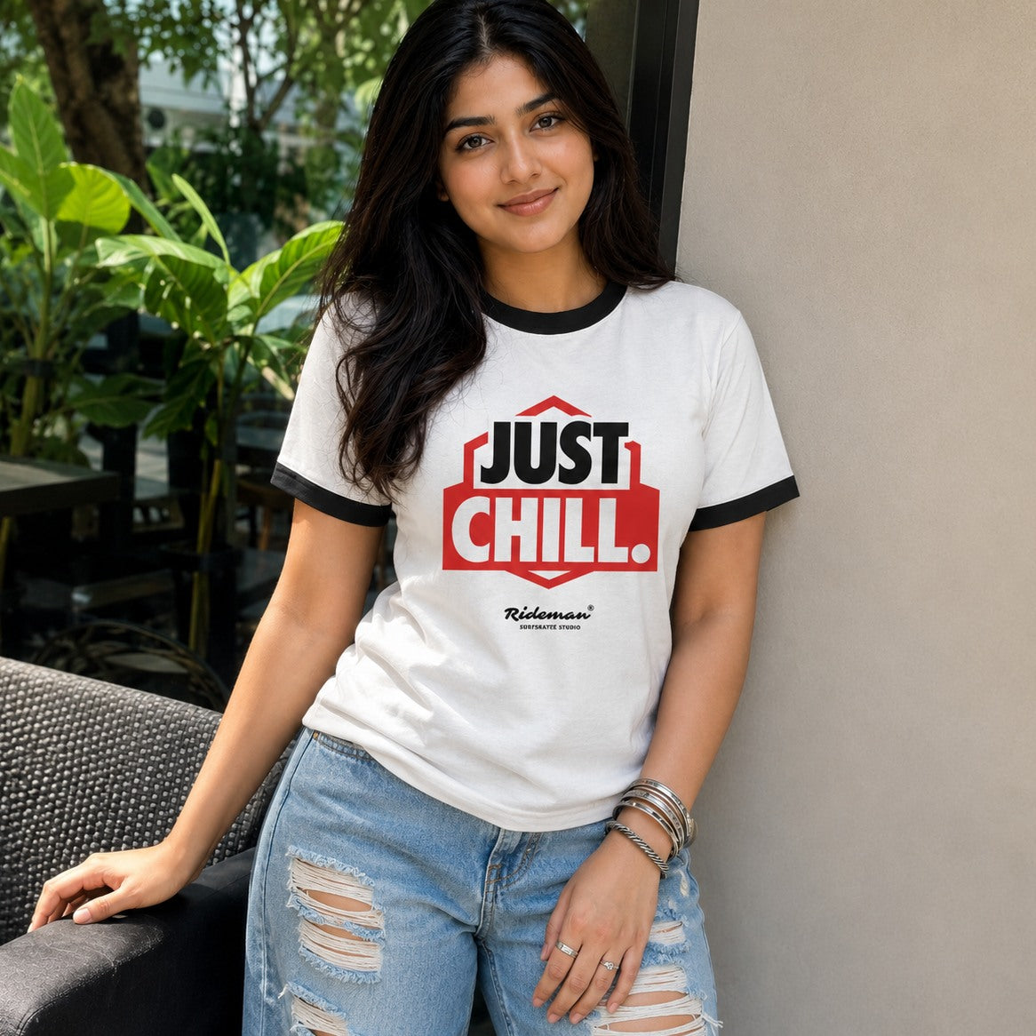 Woman wearing a 'Just Chill' t-shirt in an outdoor setting