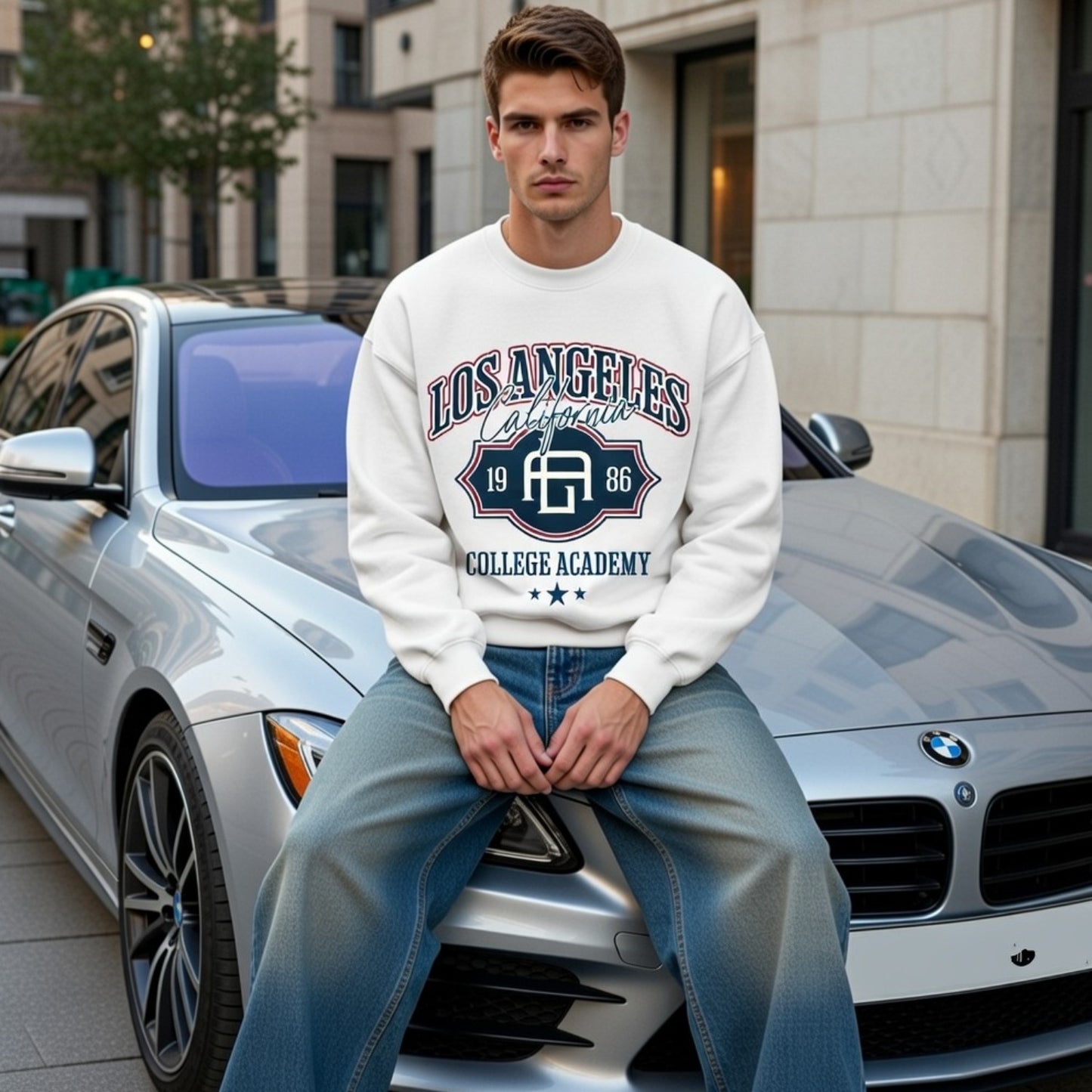 Man sitting on a car wearing a 'Los Angeles College Academy' sweatshirt in an urban setting.