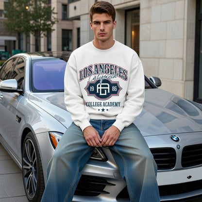 Man sitting on a car wearing a 'Los Angeles College Academy' sweatshirt in an urban setting.