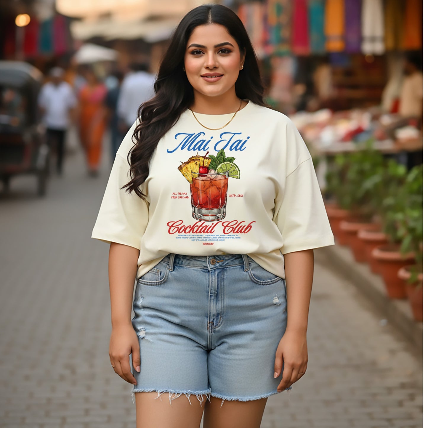 Woman wearing a 'Mai Tai Cocktail Club' t-shirt on a street background