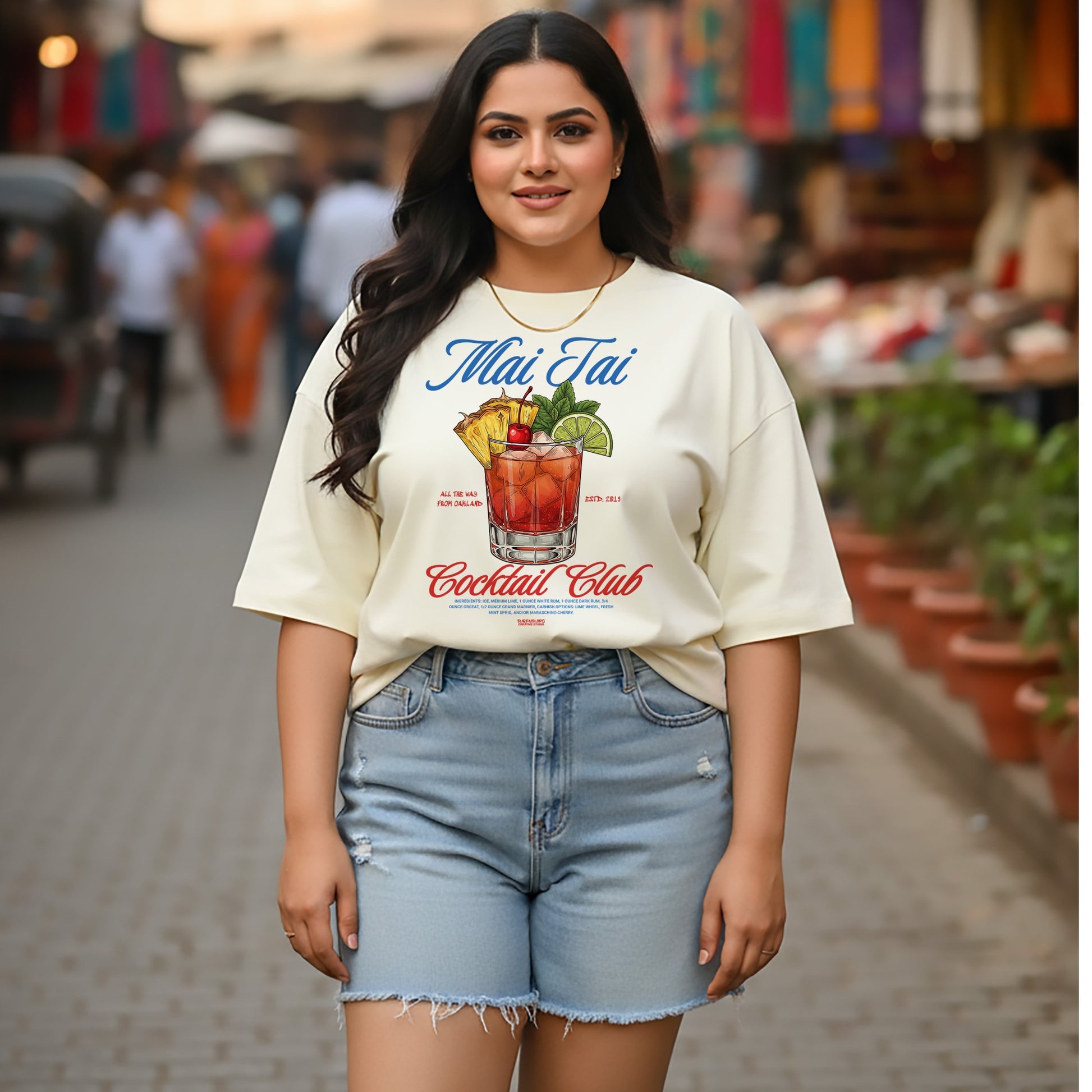 Woman wearing a 'Mai Tai Cocktail Club' t-shirt on a street background