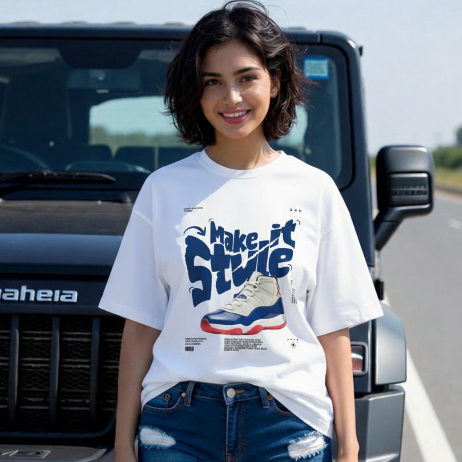 Woman wearing a white t-shirt with graphic design in front of a black SUV.