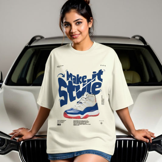 Woman wearing a t-shirt with a graphic design of a sneaker and text, standing in front of a car.