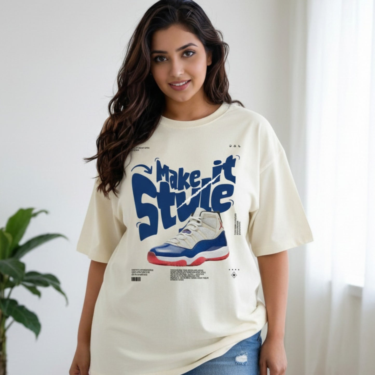 Woman wearing a cream t-shirt with a graphic design and text, standing indoors.