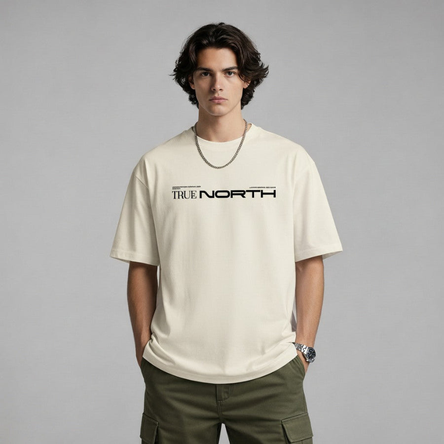 Person wearing a beige t-shirt with 'True North' text on a gray background