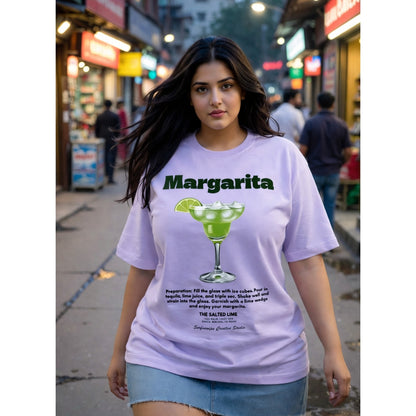 Woman wearing a purple t-shirt with 'Margarita' text and graphic on a city street.