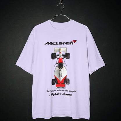 White t-shirt with McLaren Formula 1 car graphic on a dark background